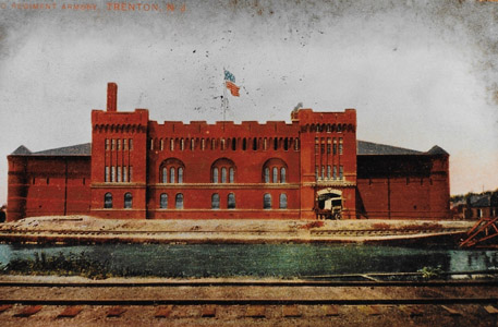 The Delaware and Raritan Canal is seen flowing in the foreground of the 2nd Regiment Armory building, located near present-day East State and Stockton Streets in Trenton.  The building, which was one of five State armories designed by the New Jersey architect Charles Alling Gifford (1860-1937), housed the city’s tax, welfare and housing records.  The armory was destroyed by fire on July 16, 1975, and the site is presently occupied in part by the Trenton City Hall Annex.